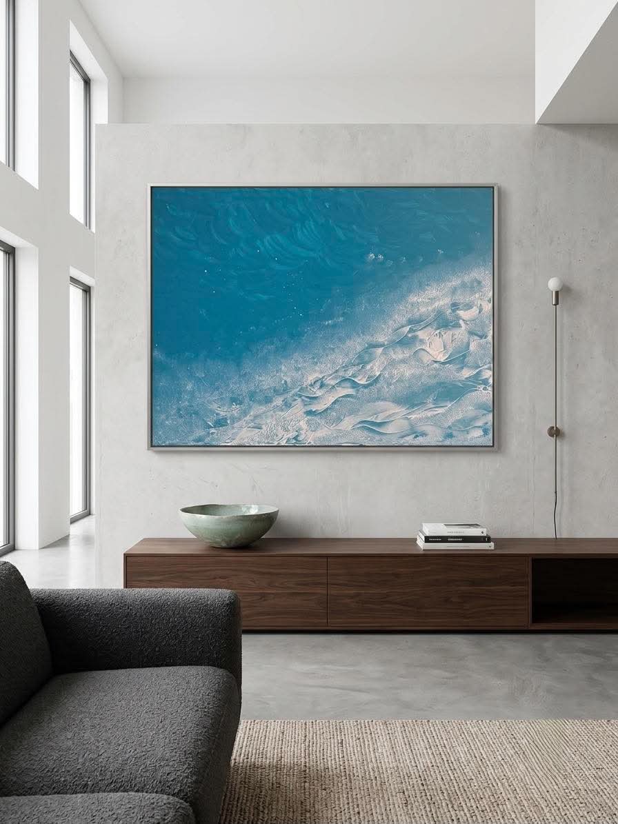 'The Ocean' by Iris Doulou — an aerial abstract seascape of deep teal water sweeping into a diagonal band of thick white impasto surf.