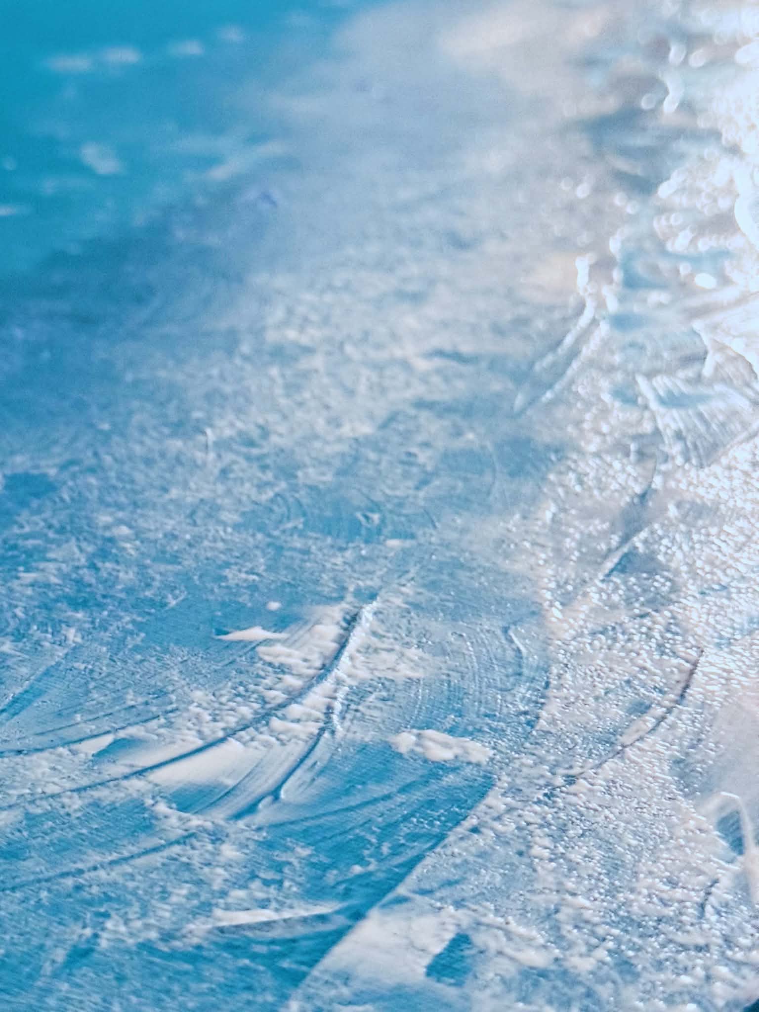 Macro detail of 'The Ocean': ridges of thick white impasto and scattered flecks rising off the teal surface.